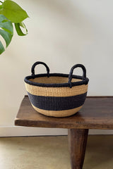 Close up of black stripe band and braided handle on Made Brave Bolga basket