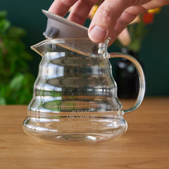 Glass teapot brewing loose leaf tea with color developing