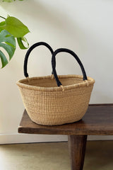 Made Brave oval market basket filled with produce on a kitchen counter