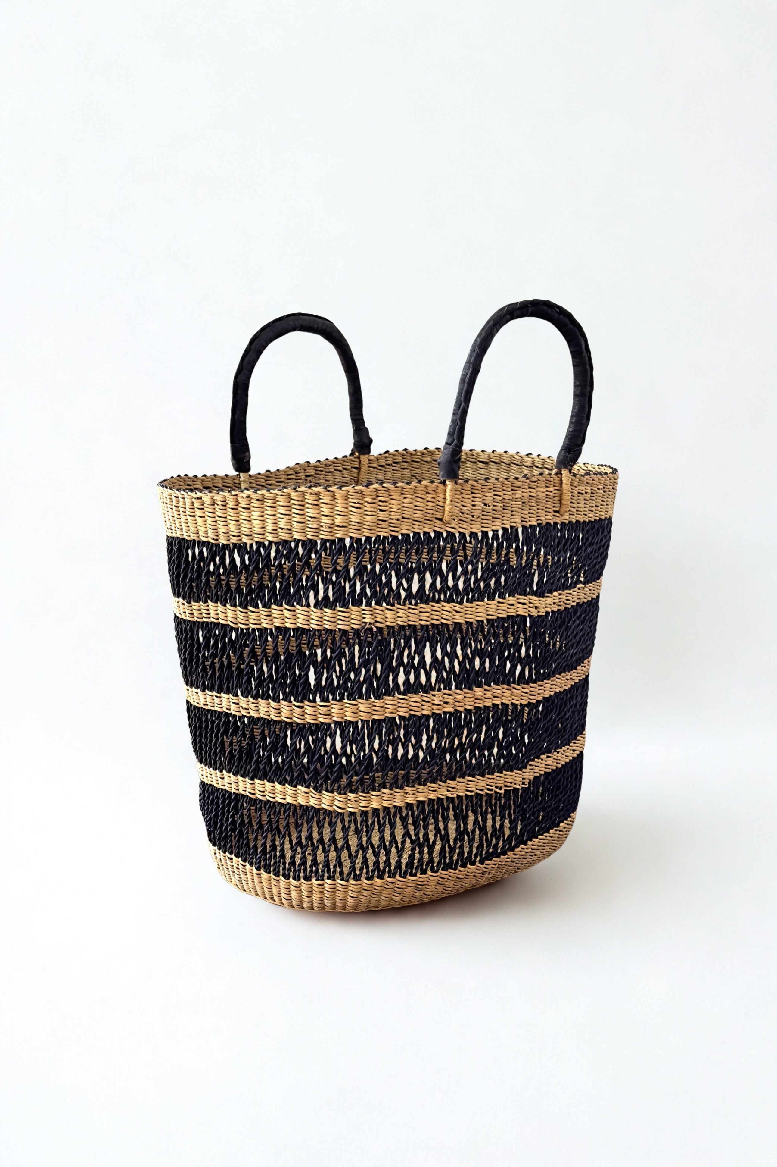 String Basket Tote in natural and black elephant grass with braided leather handles Made Brave