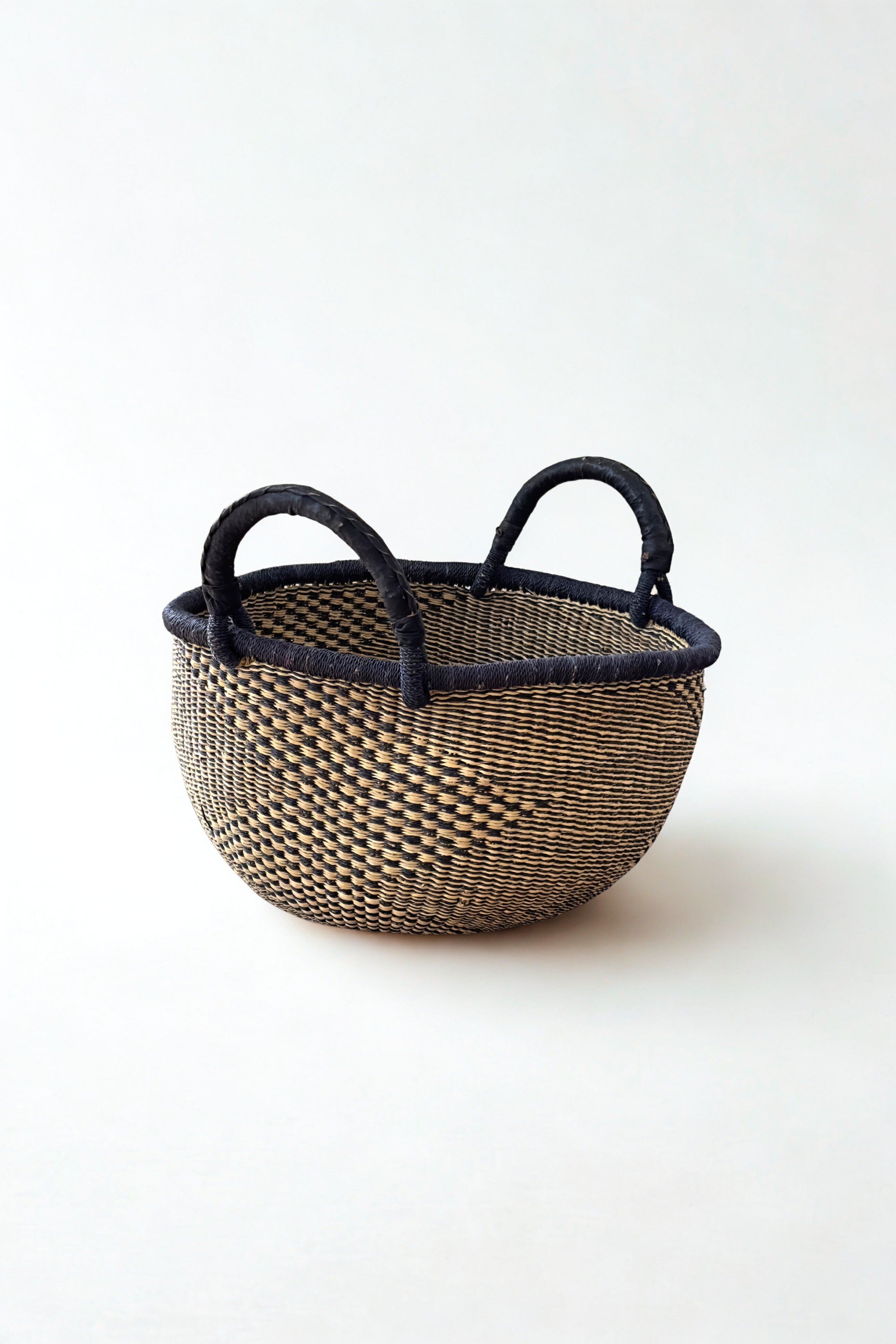 Handwoven natural and black checkerboard Bolga basket made in Ghana for Made Brave
