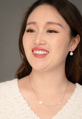Woman wearing silver sparrow necklace three birds everyday layering jewelry