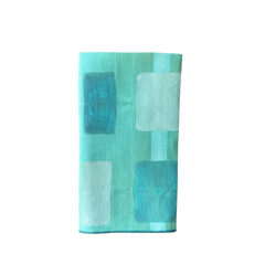 Close up of painted turquoise and seafoam pattern on Made Brave linen napkin