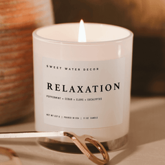 White jar soy candle burning warm glow wind down ritual