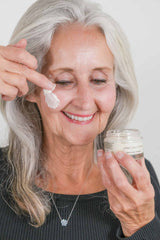Woman applying tallow anti-aging face cream for radiant mature skin