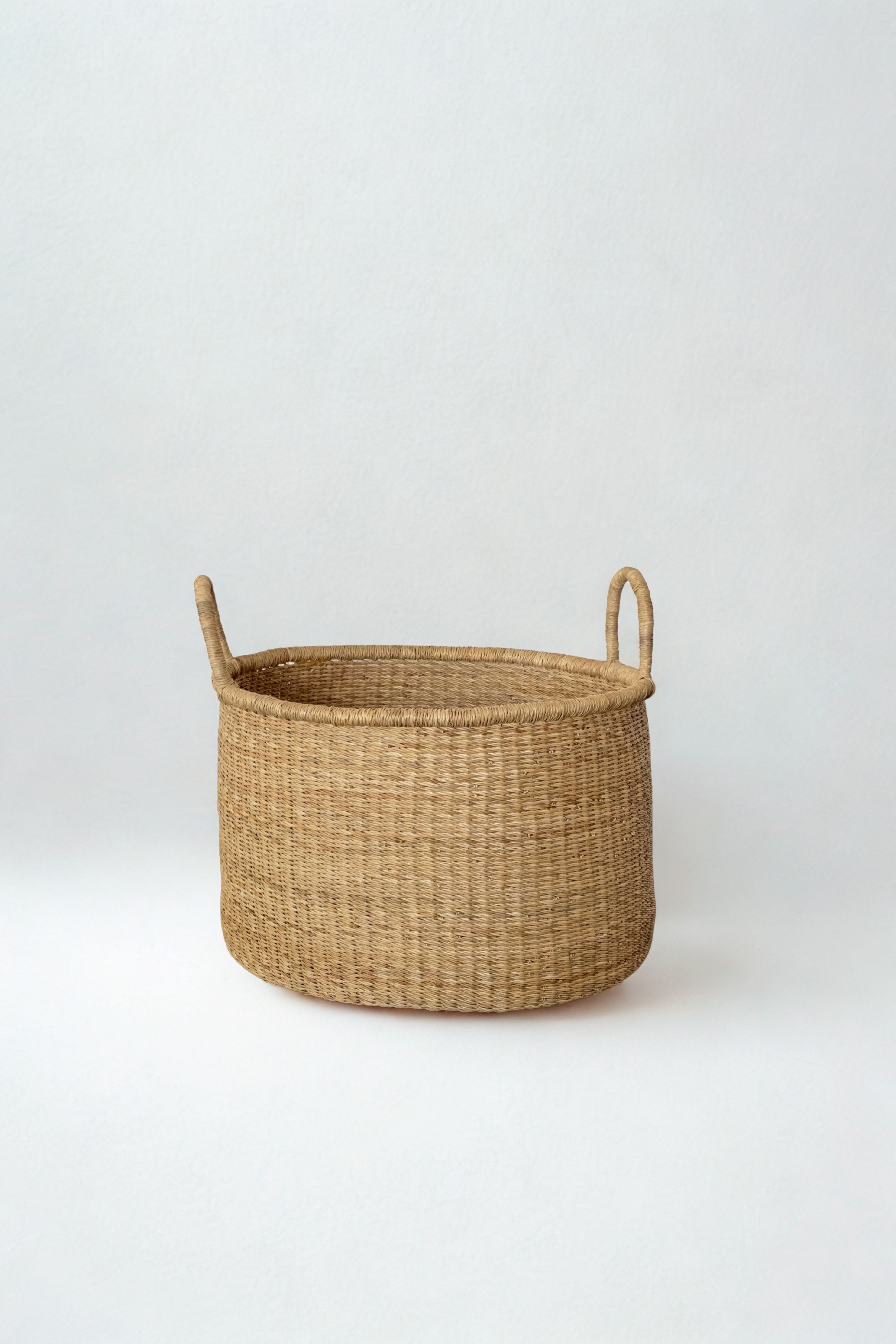 Handwoven short hamper in natural elephant grass made in Ghana for Made Brave