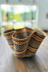 Close up of black orange and natural stripe weave on Made Brave wave basket