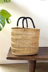 Close up of braided leather handle on Made Brave natural basket tote