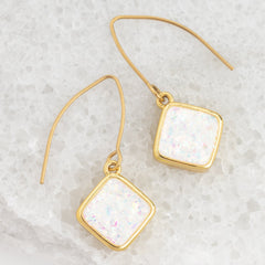 Close up of synthetic opal pendant on Made Brave Clare earrings
