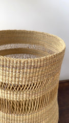 Made Brave tall planter basket holding a floor plant