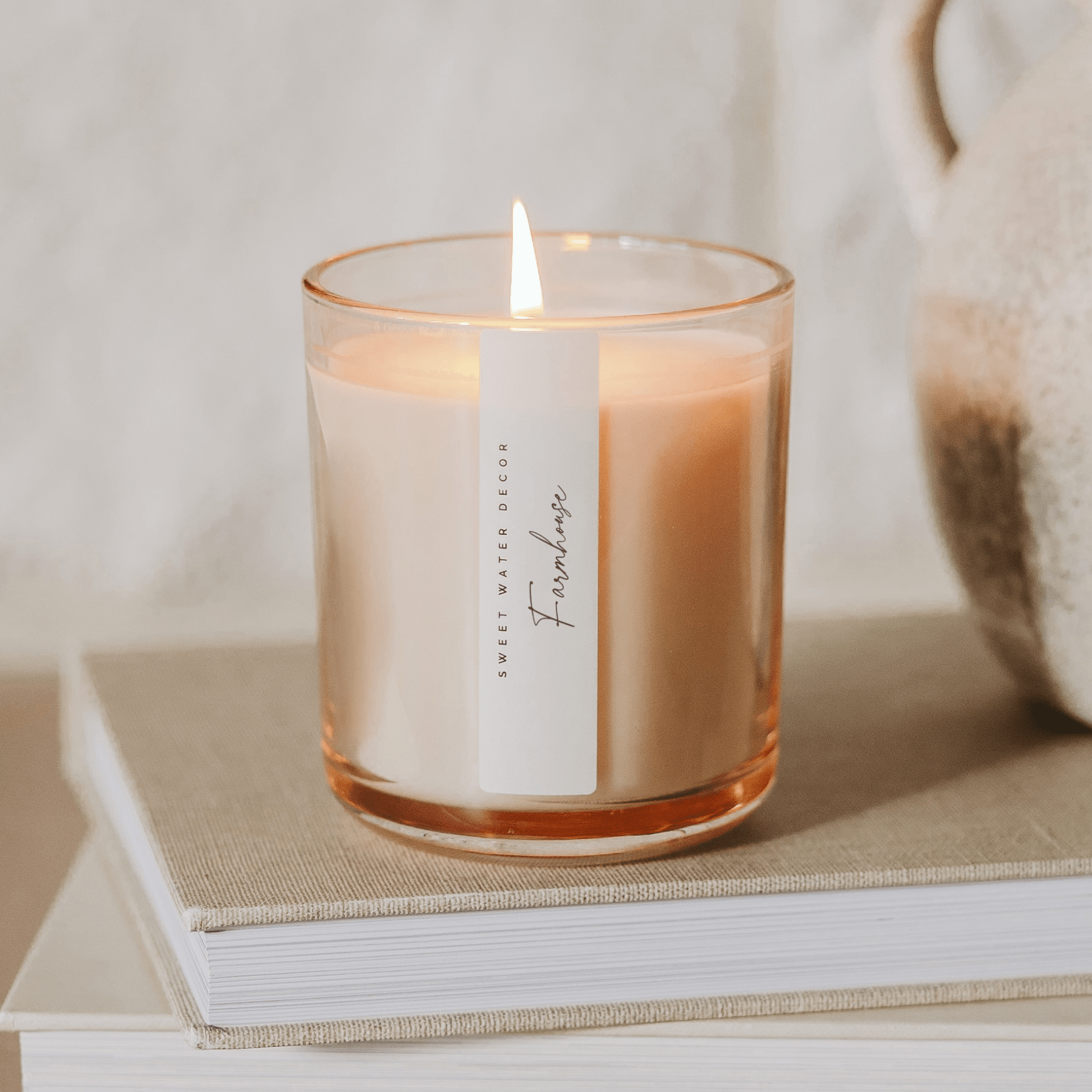 Farmhouse candle on mantel with cozy book creating warm inviting home atmosphere