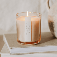 Farmhouse candle on mantel with cozy book creating warm inviting home atmosphere